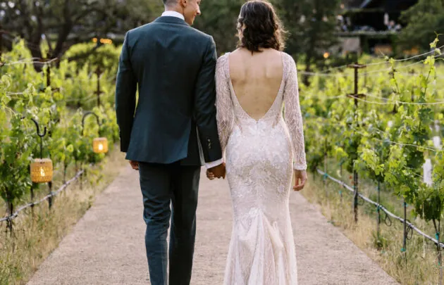 Couple walking amongst the vineyard at Healdsburg wedding