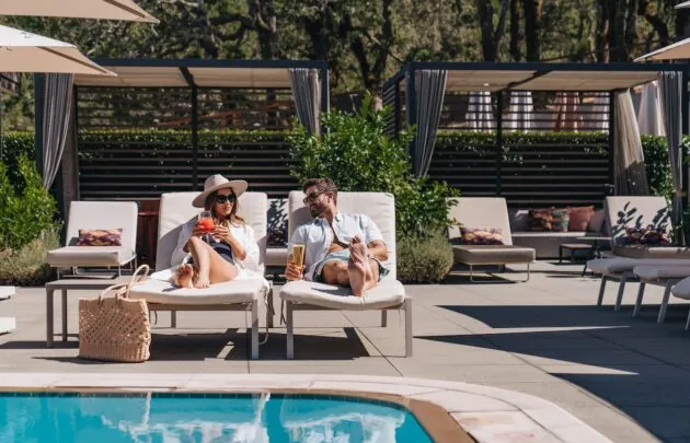 A couple lounging by the pool.