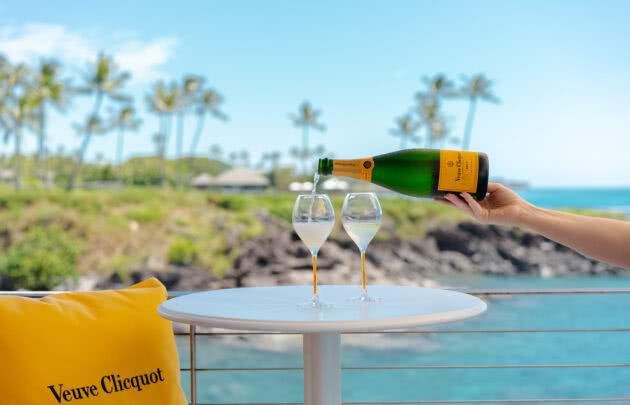 Two glasses of champagne in front of ocean views at Champagne Hale at Cliff House in Maui, HI.