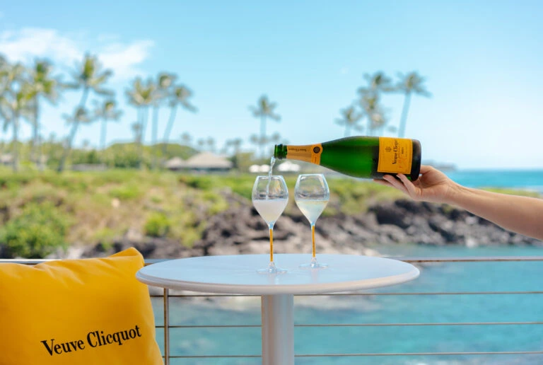 Two glasses of champagne in front of ocean views at Champagne Hale at Cliff House in Maui, HI.