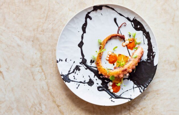 Aerial image of Charred Octopus dish from Cane & Canoe.