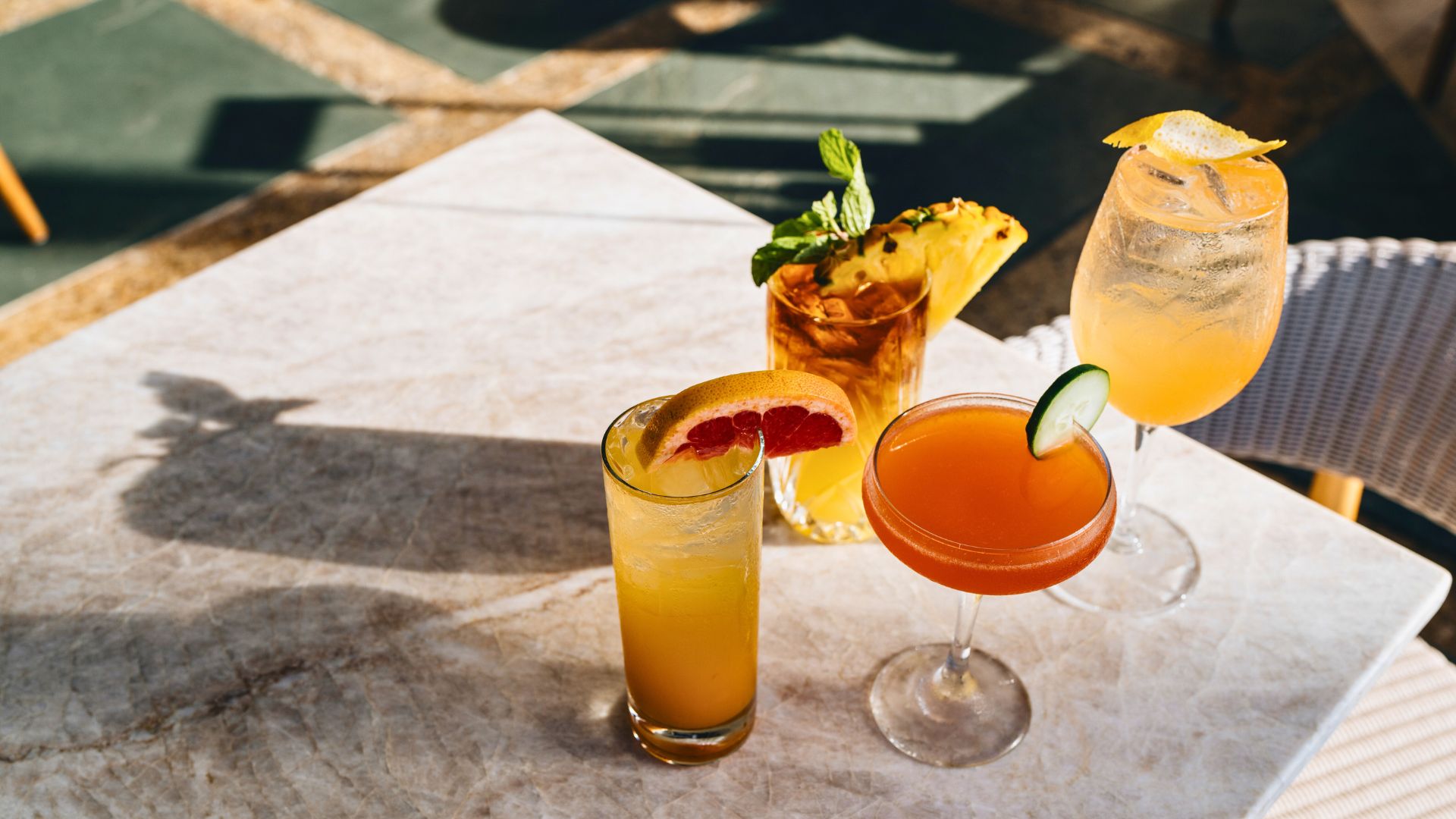 Four cocktails displayed from Cane & Canoe on table.