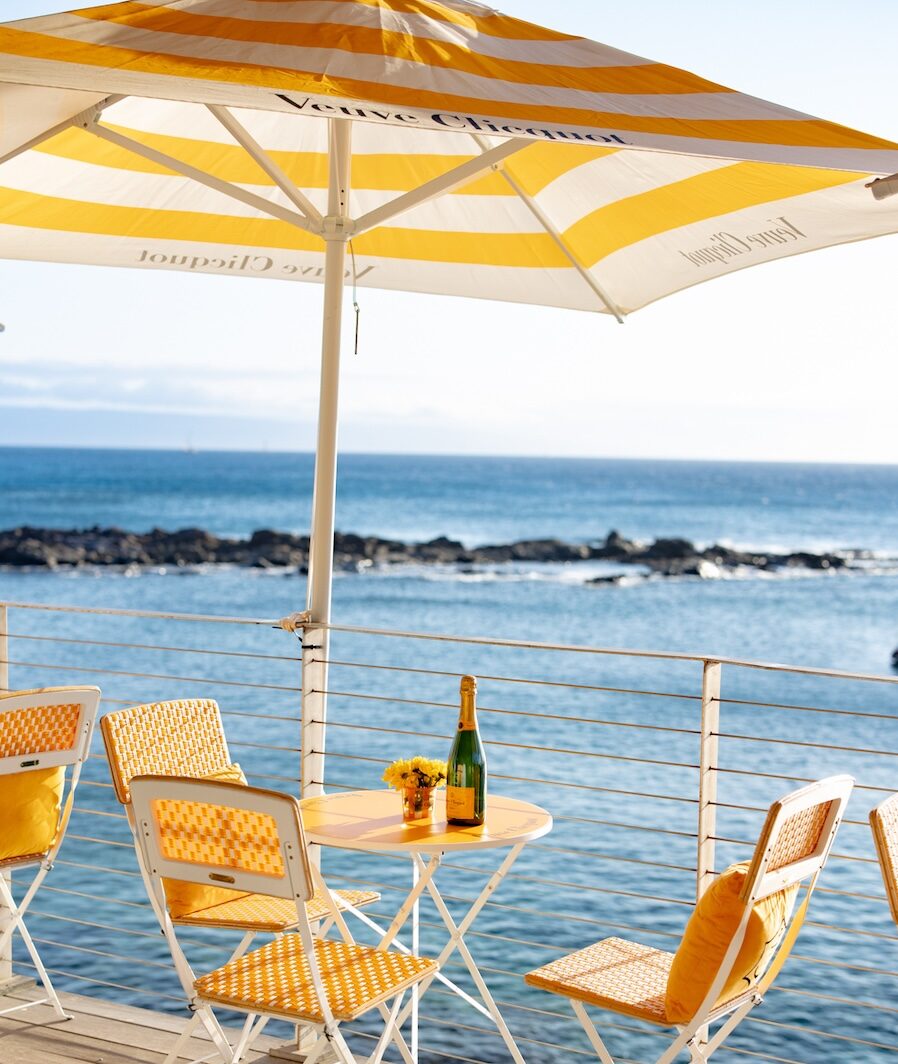 champagne on table near the ocean