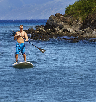 A man paddle boarding in the ocean