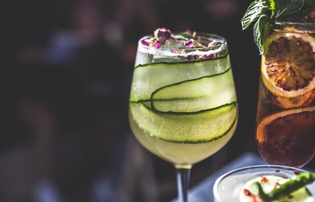 A close up of a cocktail with cucumber in it