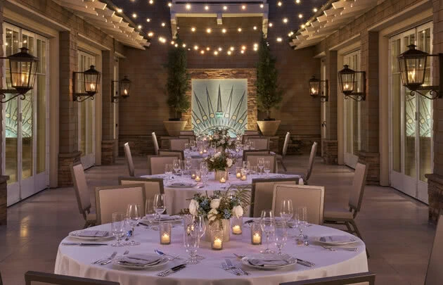 Laguna Beach event set up with table settings and candles