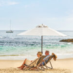 Couple relaxing on the beach in front of Montage Laguna Beach