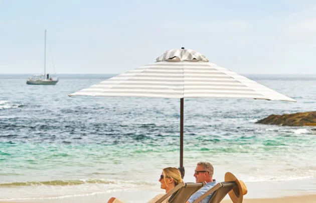 Couple relaxing on the beach in front of Montage Laguna Beach