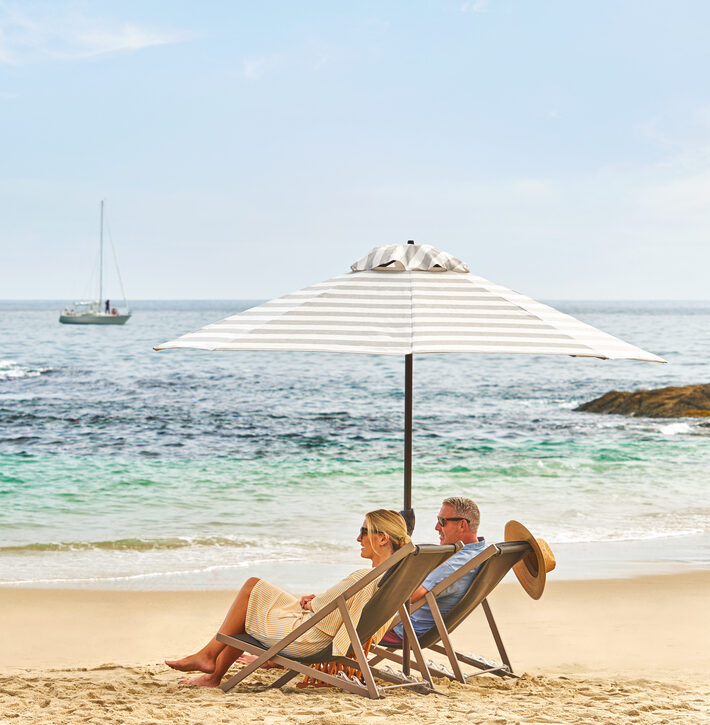 Couple relaxing on the beach in front of Montage Laguna Beach