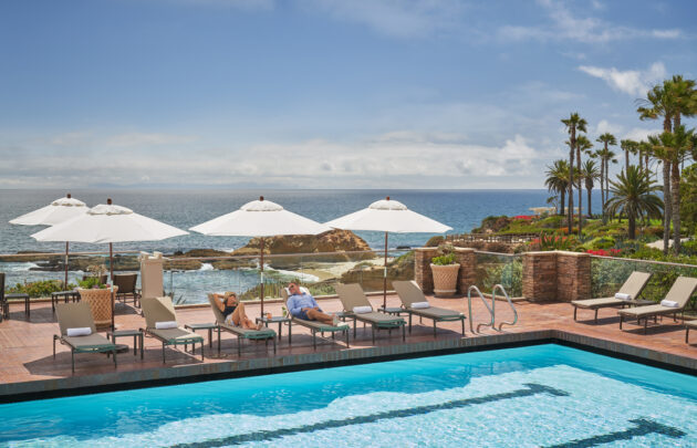 Couple relaxing at Spa Montage pool overlooking Pacific Ocean