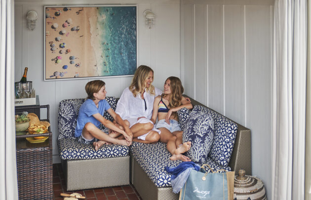 Family relaxing in private cabana by the Mosaic Pool