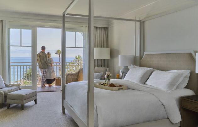 Couple looking at ocean view from guestroom balcony at Montage Laguna Beach