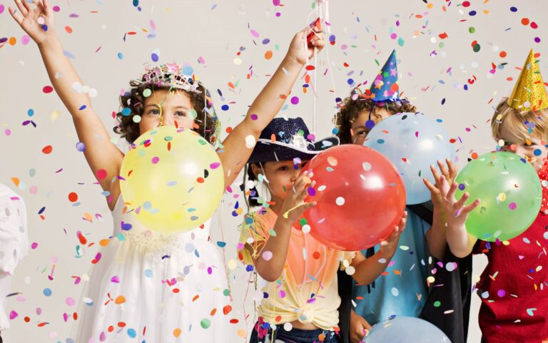 Children celebrating with balloons at New Year's Eve party