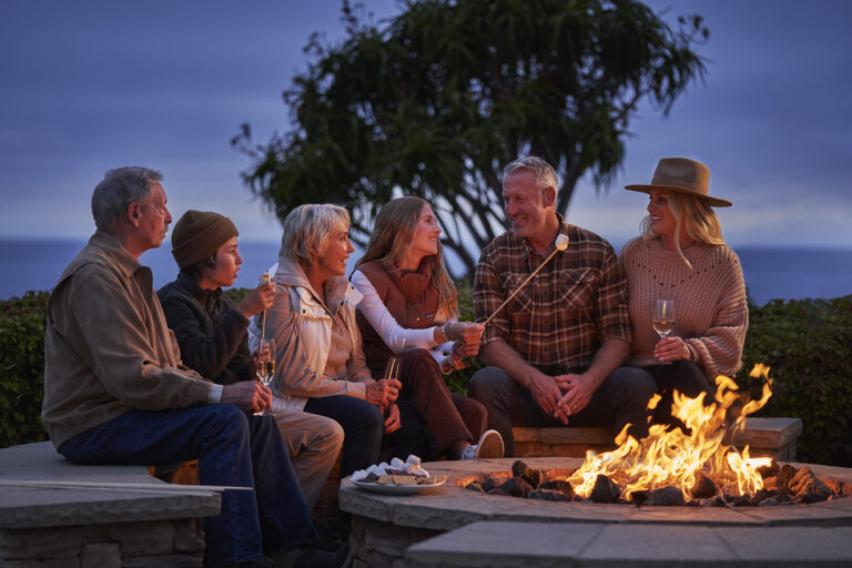 A family making s'mores by the fire at Montage Laguna Beach