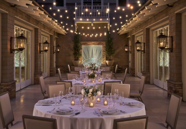 outdoor dining setup with glasses and flowers