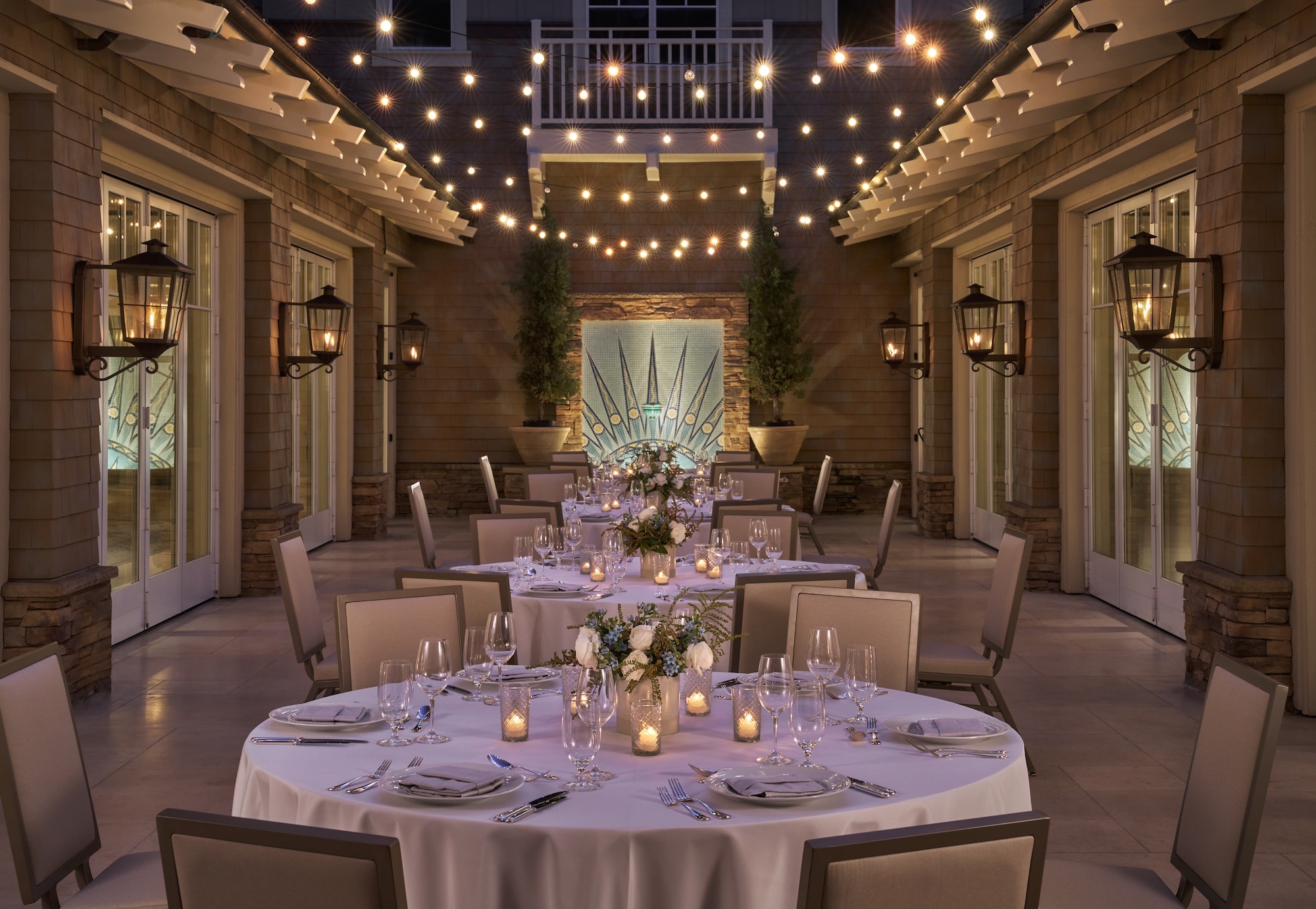 outdoor dining setup with glasses and flowers