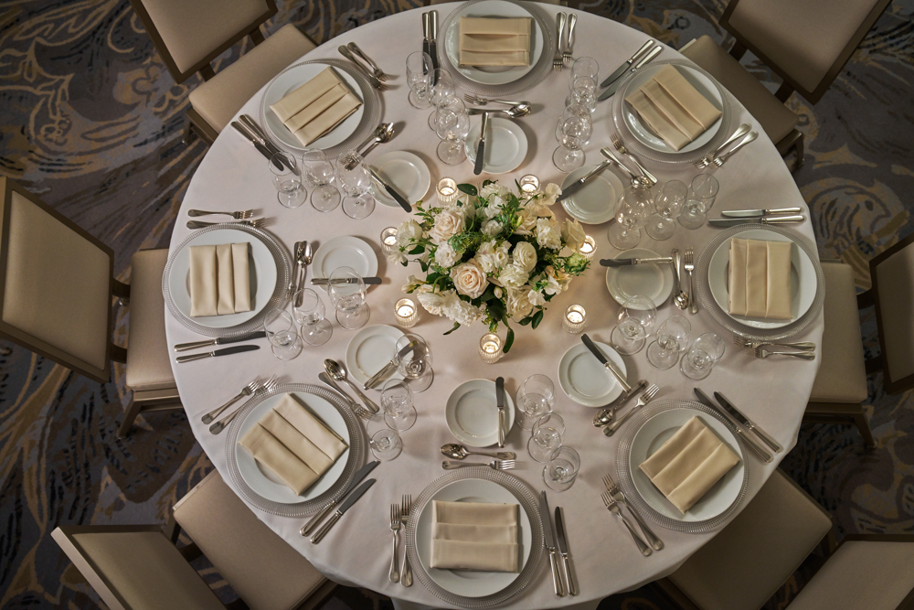 table set with glasses and flowers