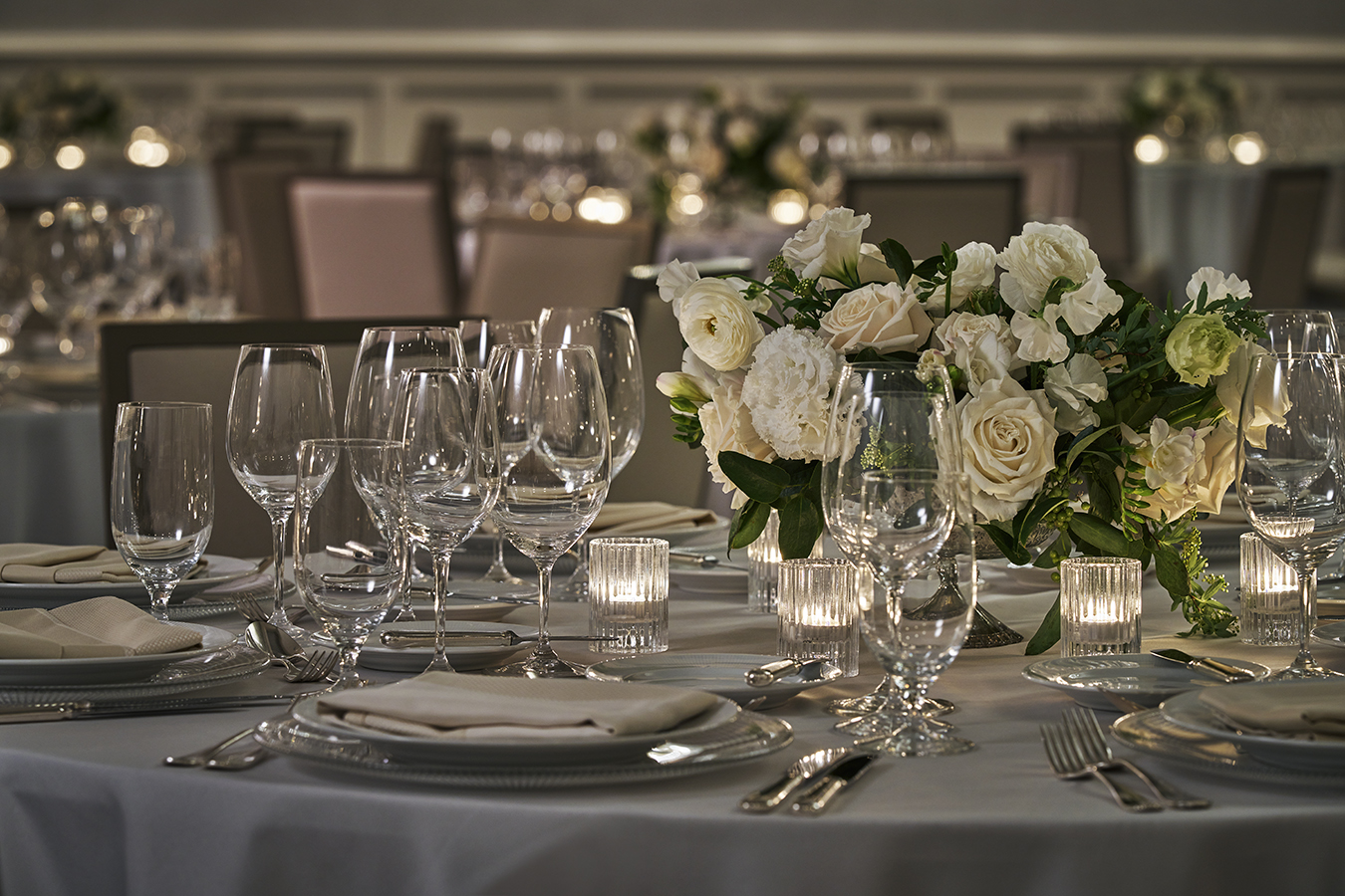 table set with glasses and flowers