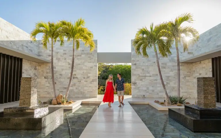 A couple walking through the Luxury Montage Los Cabos Resort