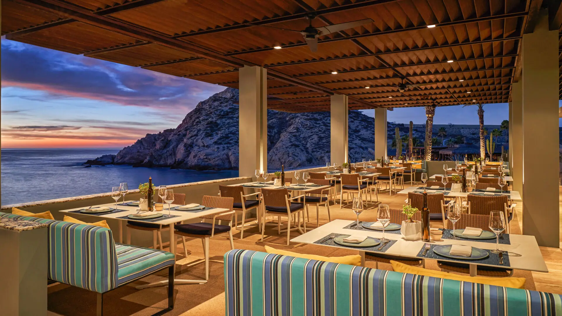 The outdoor patio of Marea at Montage Los Cabos at sunset