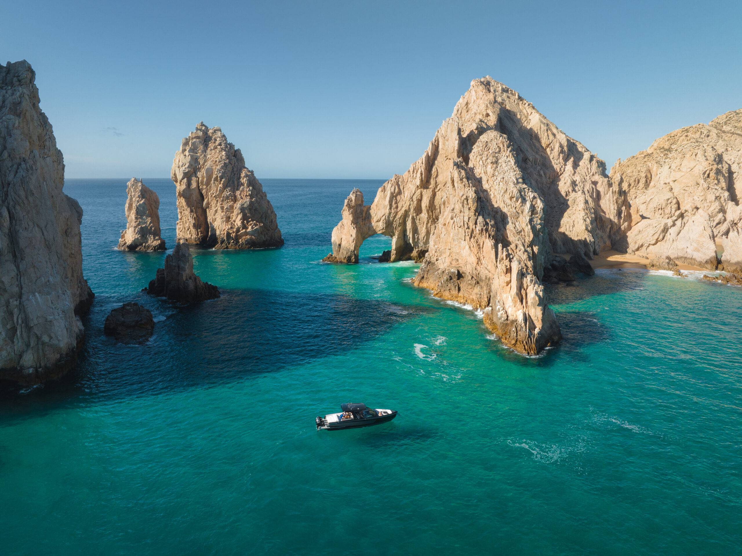 A boat in the crystal blue water near Montage Los Cabos - a 5 star hotel