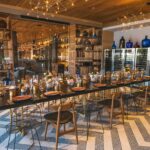 A dining room with a long table and chairs at Mezcal