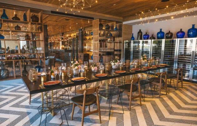 A dining room with a long table and chairs at Mezcal