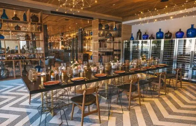 A dining room with a long table and chairs at Mezcal