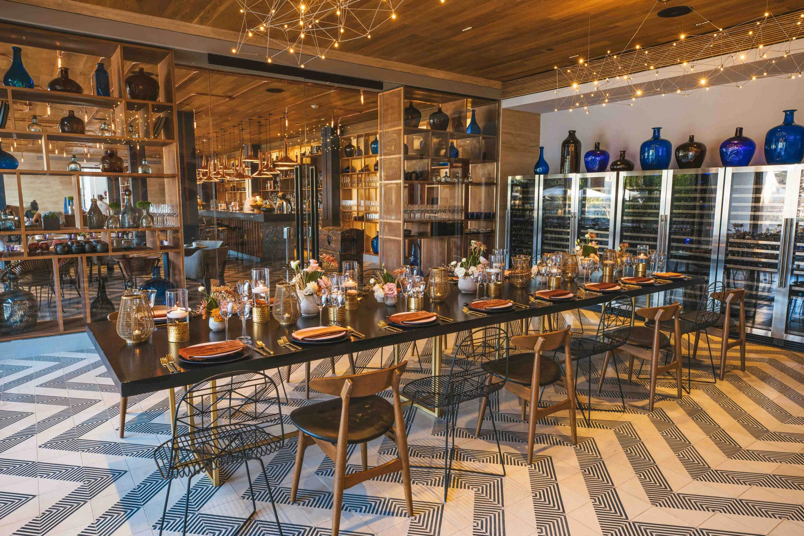 A dining room with a long table and chairs at Mezcal
