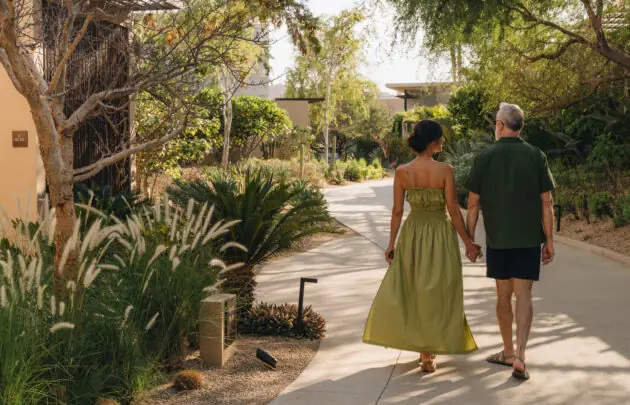 A couple walking on the grounds of Montage Los Cabos.