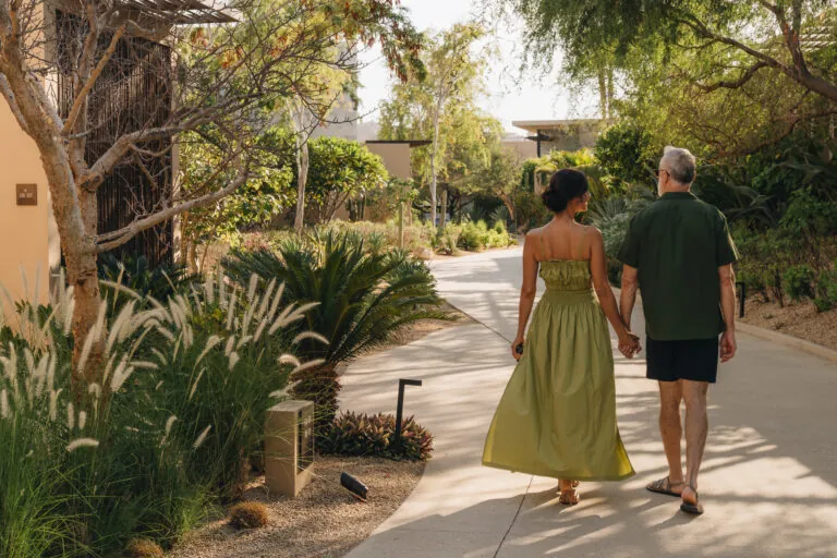 A couple walking on the grounds of Montage Los Cabos.