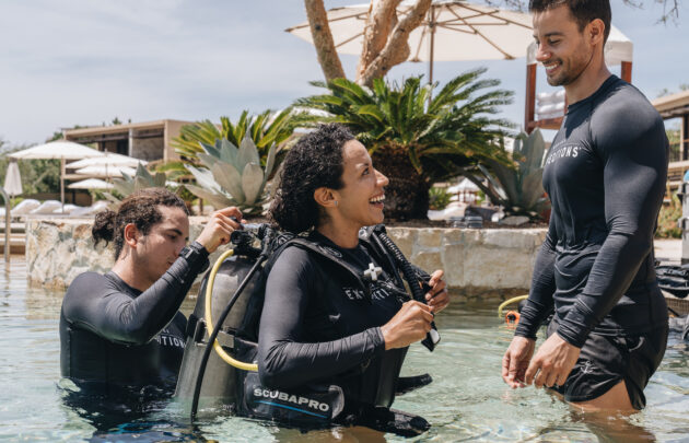 Woman exiting pool after scuba diving experience at Montage Los Cabos