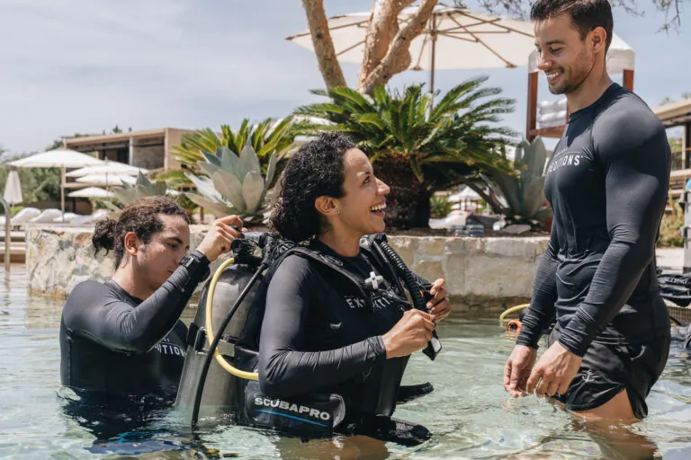 Woman exiting pool after scuba diving experience at Montage Los Cabos