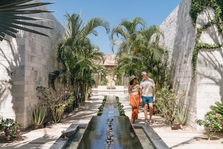 Couple walking along water feature at Montage Los Cabos