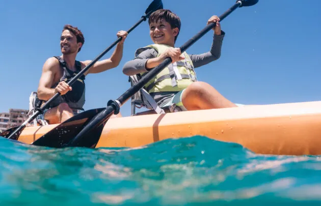 Father and son kayaking in Santa Maria Bay.
