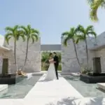 bride and groom outside with palm trees