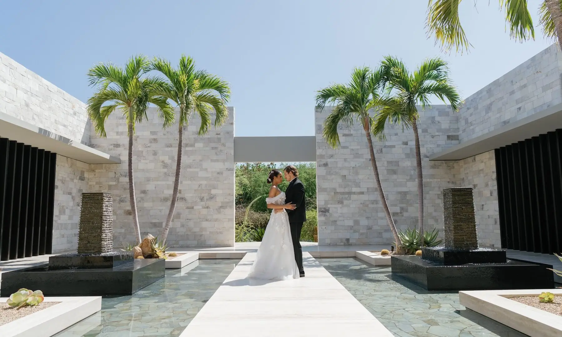 bride and groom outside with palm trees