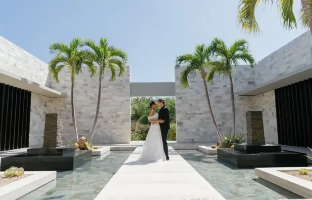 bride and groom outside with palm trees
