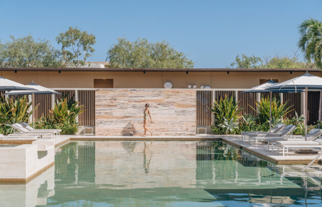 A woman walking by the pool at Montage Los Cabos