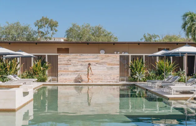 A woman walking by the pool at Montage Los Cabos