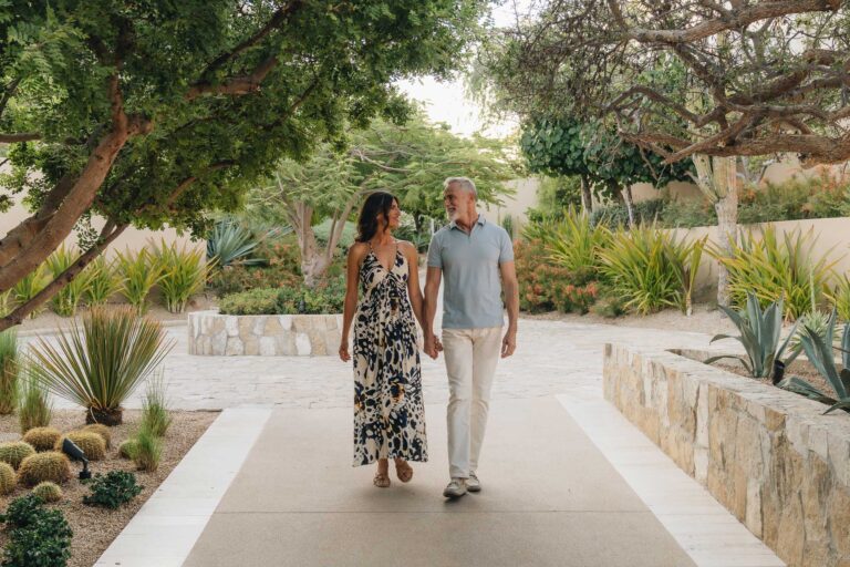 A couple walking on the grounds of Montage Los Cabos