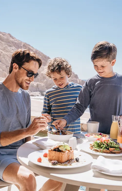 Father eating with his two children at Montage Los Cabos