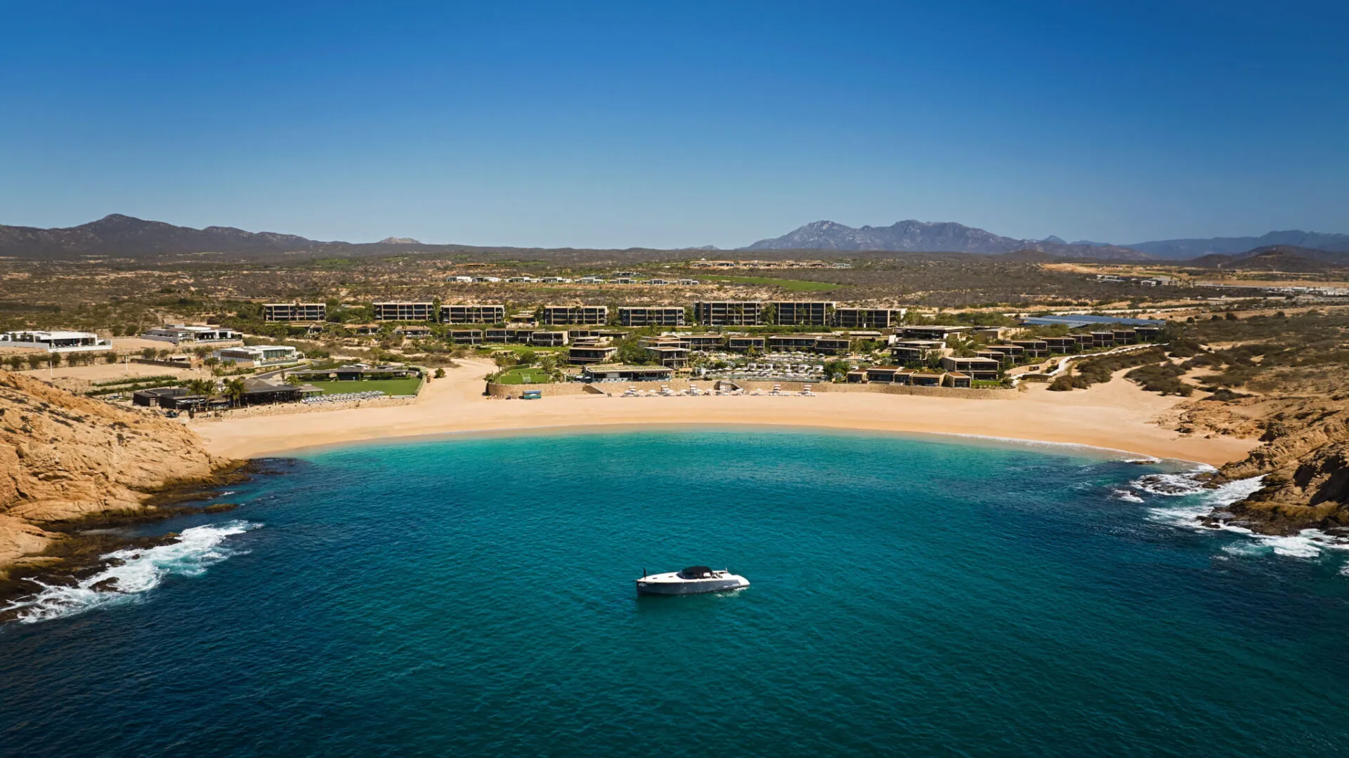 A boat in the ocean next to Montage Los Cabos