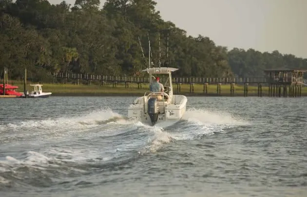 Boat headed toward dock with wake