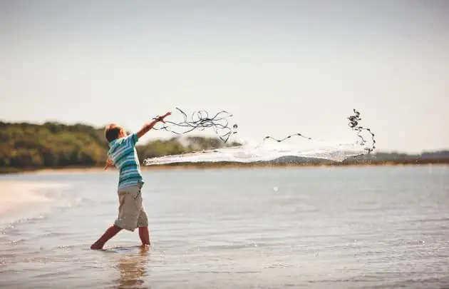 Boy playing on sandbar
