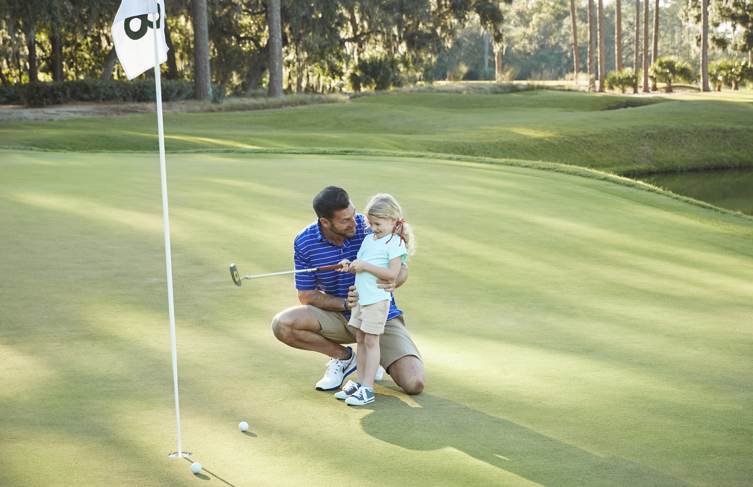 Father and daughter golfing