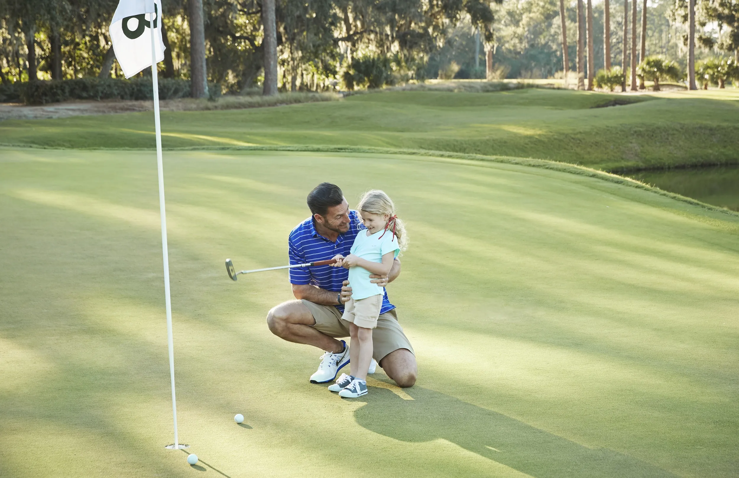 Father and daughter golfing