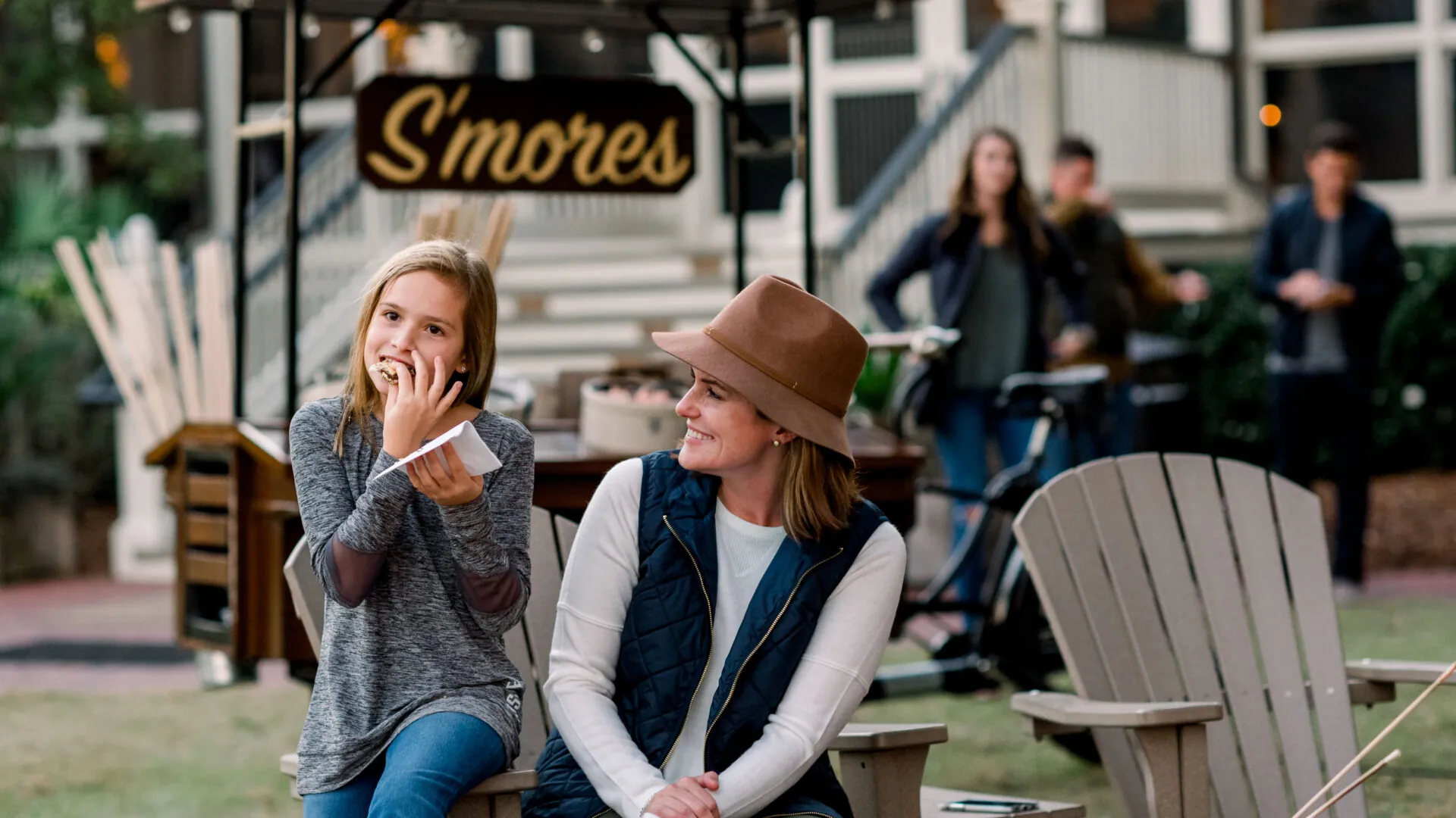 mother and daughter enjoying s'mores outdoors at Montage Palmetto Bluff