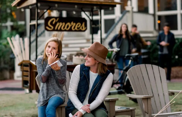 mother and daughter enjoying s'mores outdoors at Montage Palmetto Bluff