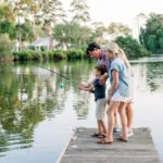 family fishing on dock